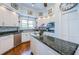 Bright kitchen featuring white cabinets, a center island, and stainless steel appliances at 1988 Carolina Ne Cir, St Petersburg, FL 33703