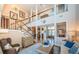 Open-concept living room showcasing the staircase, high ceilings, and neutral wall color at 1988 Carolina Ne Cir, St Petersburg, FL 33703