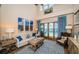 Bright living room with high ceilings, coastal decor, and sliding doors to the pool area at 1988 Carolina Ne Cir, St Petersburg, FL 33703