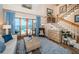 Bright living room features staircase, water views, and decorative blue curtains at 1988 Carolina Ne Cir, St Petersburg, FL 33703