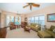 Inviting living room with water views, comfortable seating, ceiling fans, and access to outdoor spaces at 1988 Carolina Ne Cir, St Petersburg, FL 33703