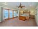 Tranquil main bedroom featuring water view, tray ceiling, wooden furniture and natural light at 1988 Carolina Ne Cir, St Petersburg, FL 33703