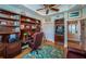 Well-lit office with built-in bookshelves, desk and a colorful fish-themed rug adding character at 1988 Carolina Ne Cir, St Petersburg, FL 33703