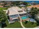 Beautiful home featuring a screened-in pool, lush lawn, and outdoor seating area for relaxing and entertaining at 1988 Carolina Ne Cir, St Petersburg, FL 33703