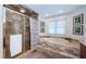 A marble-clad bathroom showcasing an alcove soaking tub and a glass enclosed shower at 1988 Carolina Ne Cir, St Petersburg, FL 33703