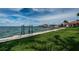 A lush green lawn meets a waterfront with a dock in the distance at 1988 Carolina Ne Cir, St Petersburg, FL 33703
