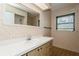 This bathroom features a vanity with drawers, a large mirror, and a window at 2035 Nolan Dr, Dunedin, FL 34698
