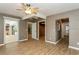 This bedroom has wood-look floors, a ceiling fan, and access to multiple rooms at 2035 Nolan Dr, Dunedin, FL 34698