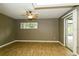 This bedroom boasts a ceiling fan, wood-look flooring, and a sliding door to the patio at 2035 Nolan Dr, Dunedin, FL 34698