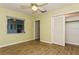 Bright bedroom featuring wood-look floors, overhead fan, and closet space at 2035 Nolan Dr, Dunedin, FL 34698