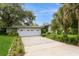Charming single-story home featuring a two-car garage, well-maintained landscaping, and a concrete driveway at 2035 Nolan Dr, Dunedin, FL 34698