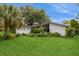 Well-maintained home exterior features a manicured lawn and mature landscaping at 2035 Nolan Dr, Dunedin, FL 34698