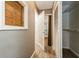 This hallway leads to multiple rooms and has wood-look flooring and closet space at 2035 Nolan Dr, Dunedin, FL 34698