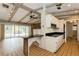 Eat-in kitchen with breakfast bar, light wood cabinets, and view of large living area with stone fireplace at 2035 Nolan Dr, Dunedin, FL 34698