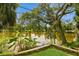 Breathtaking lake views from the property, showcasing lush greenery and waterfront serenity at 2035 Nolan Dr, Dunedin, FL 34698