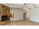 Spacious living area boasts a stone fireplace, built-in shelving, and wood-look flooring at 2035 Nolan Dr, Dunedin, FL 34698