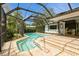 A stunning screened-in pool and spa with patio and screened enclosure at 2035 Nolan Dr, Dunedin, FL 34698