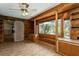 Cozy sun room with light-toned wood panels, sliding barn door and built in shelving at 2035 Nolan Dr, Dunedin, FL 34698