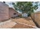 Backyard featuring a storage shed, fence, landscaping, and stepping stones at 2063 Ridgecrest Dr, Dunedin, FL 34698