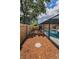 Fenced yard and stepping stone path leading to a screened-in pool area at 2063 Ridgecrest Dr, Dunedin, FL 34698