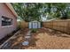 Backyard with a storage shed, surrounded by a wooden fence and mulch at 2063 Ridgecrest Dr, Dunedin, FL 34698