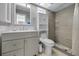 Updated bathroom with a shower, gray vanity, and toilet at 2063 Ridgecrest Dr, Dunedin, FL 34698