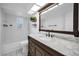 Bathroom features a marble countertop vanity with a vintage framed mirror at 2063 Ridgecrest Dr, Dunedin, FL 34698