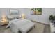 Bedroom furnished with a white bed set, matching nightstands and a bench at 2063 Ridgecrest Dr, Dunedin, FL 34698