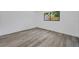 This bedroom features modern gray flooring and a window at 2063 Ridgecrest Dr, Dunedin, FL 34698