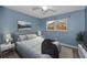 A bedroom with an art piece, ceiling fan, and view into the backyard at 2063 Ridgecrest Dr, Dunedin, FL 34698