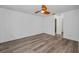 Spacious bedroom featuring wood-look floors, a ceiling fan, and a walk-in closet at 2063 Ridgecrest Dr, Dunedin, FL 34698