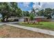 Well-maintained single-story home featuring a two-car garage, stone accents, and tropical landscaping at 2063 Ridgecrest Dr, Dunedin, FL 34698