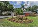 Single-story home boasting a beautiful front yard garden, stone accents, and a side-entry two-car garage at 2063 Ridgecrest Dr, Dunedin, FL 34698
