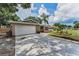Spacious single-story home with a two-car garage, stone accents, and a manicured front yard at 2063 Ridgecrest Dr, Dunedin, FL 34698