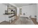 Open-concept kitchen with breakfast bar, stainless steel appliances, and adjacent breakfast nook at 2063 Ridgecrest Dr, Dunedin, FL 34698