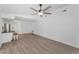 An empty living room with light wood-look floors, leading to other rooms in the house at 2063 Ridgecrest Dr, Dunedin, FL 34698