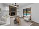 Cozy living room with a stone fireplace, modern furniture, and view of the backyard pool at 2063 Ridgecrest Dr, Dunedin, FL 34698
