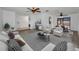 Bright living room with modern furniture, ceiling fan, and view to the dining area and outdoor pool at 2063 Ridgecrest Dr, Dunedin, FL 34698