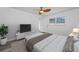 Bright main bedroom featuring a ceiling fan, wood-look floors, and a window with a backyard view at 2063 Ridgecrest Dr, Dunedin, FL 34698
