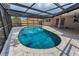 Screened pool with brick paver deck and access to the home's exterior at 2063 Ridgecrest Dr, Dunedin, FL 34698