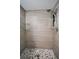 Updated walk-in shower features modern tile and mosaic flooring at 2063 Ridgecrest Dr, Dunedin, FL 34698