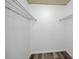 A walk-in closet is equipped with shelving and wood-look floors at 2063 Ridgecrest Dr, Dunedin, FL 34698