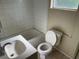 Bathroom with standard features including a toilet, sink, and bathtub at 2219 Durham St, Tampa, FL 33605