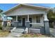 Charming single-story home featuring a front porch and symmetrical design at 2219 Durham St, Tampa, FL 33605