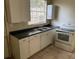 Functional kitchen featuring basic appliances and ample cabinet space at 2219 Durham St, Tampa, FL 33605