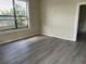 Bright living room featuring large windows and wood-look floors at 2219 Durham St, Tampa, FL 33605