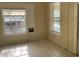 Living room featuring tiled floor, two windows, and doorway at 2219 Durham St, Tampa, FL 33605