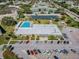 Aerial view features a clubhouse with a pool, solar panels, and ample parking surrounded by lush landscaping at 2261 Swedish Dr # 47, Clearwater, FL 33763