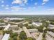 Aerial view of a sprawling community with condominium complexes, green spaces, and a tranquil lake in the background at 2261 Swedish Dr # 47, Clearwater, FL 33763