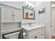Bathroom featuring a white vanity with a framed mirror, and a walk-in shower at 2261 Swedish Dr # 47, Clearwater, FL 33763